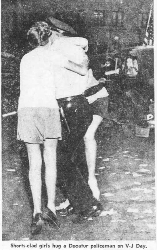 Girls hug policeman on V-J Day